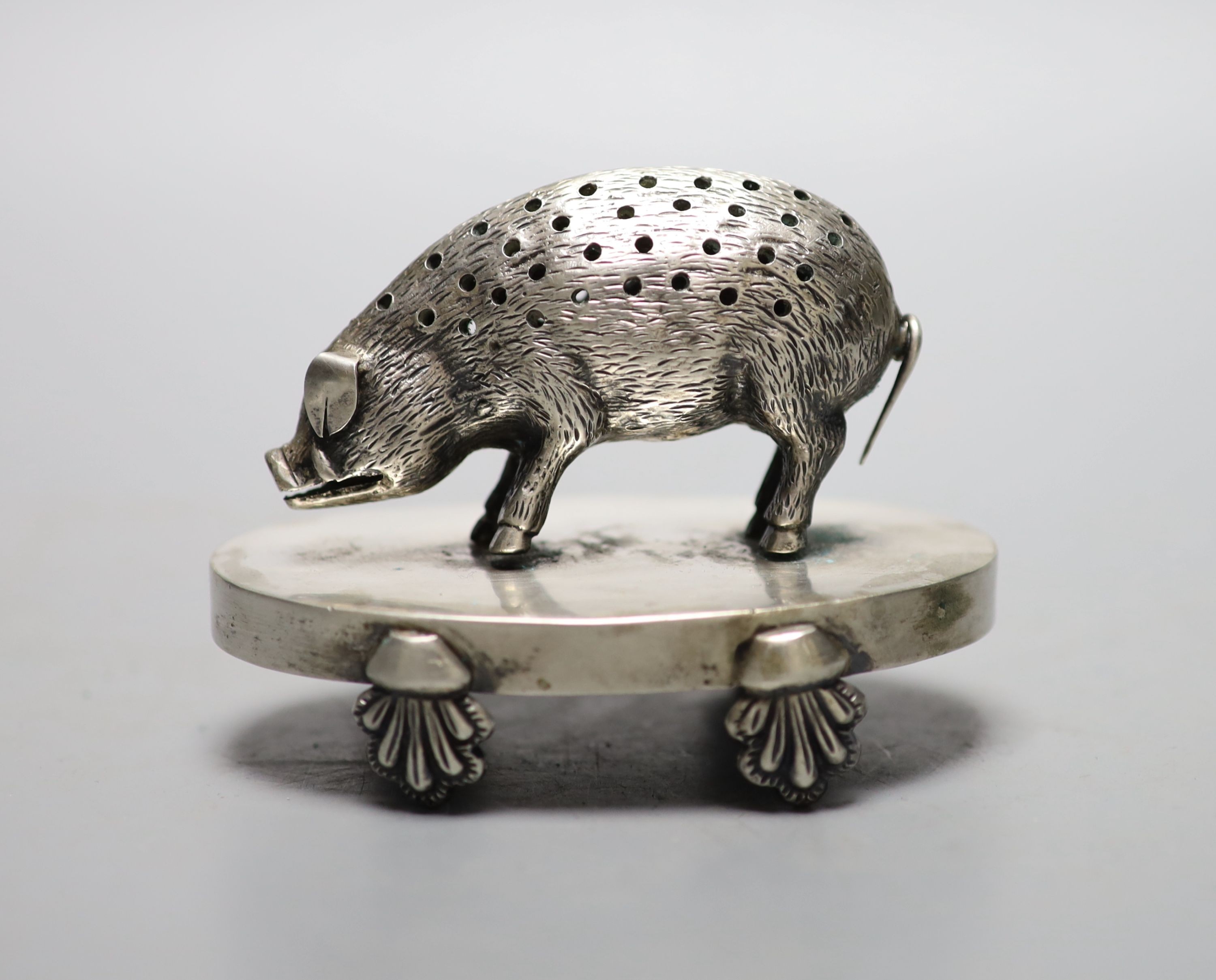 A continental white metal novelty oval toothpick holder, modelled as a pig on an oval base, 91mm, indistinct marks.